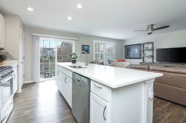 a kitchen with sink stove and refrigerator