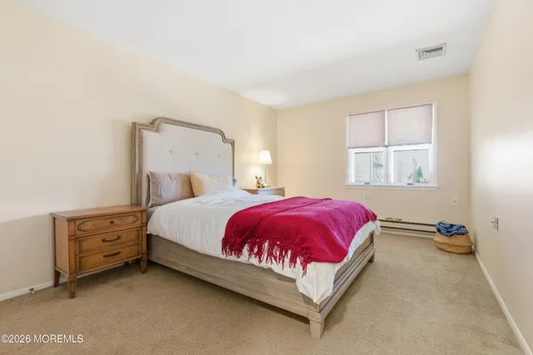 a bed sitting in a bedroom next to a window