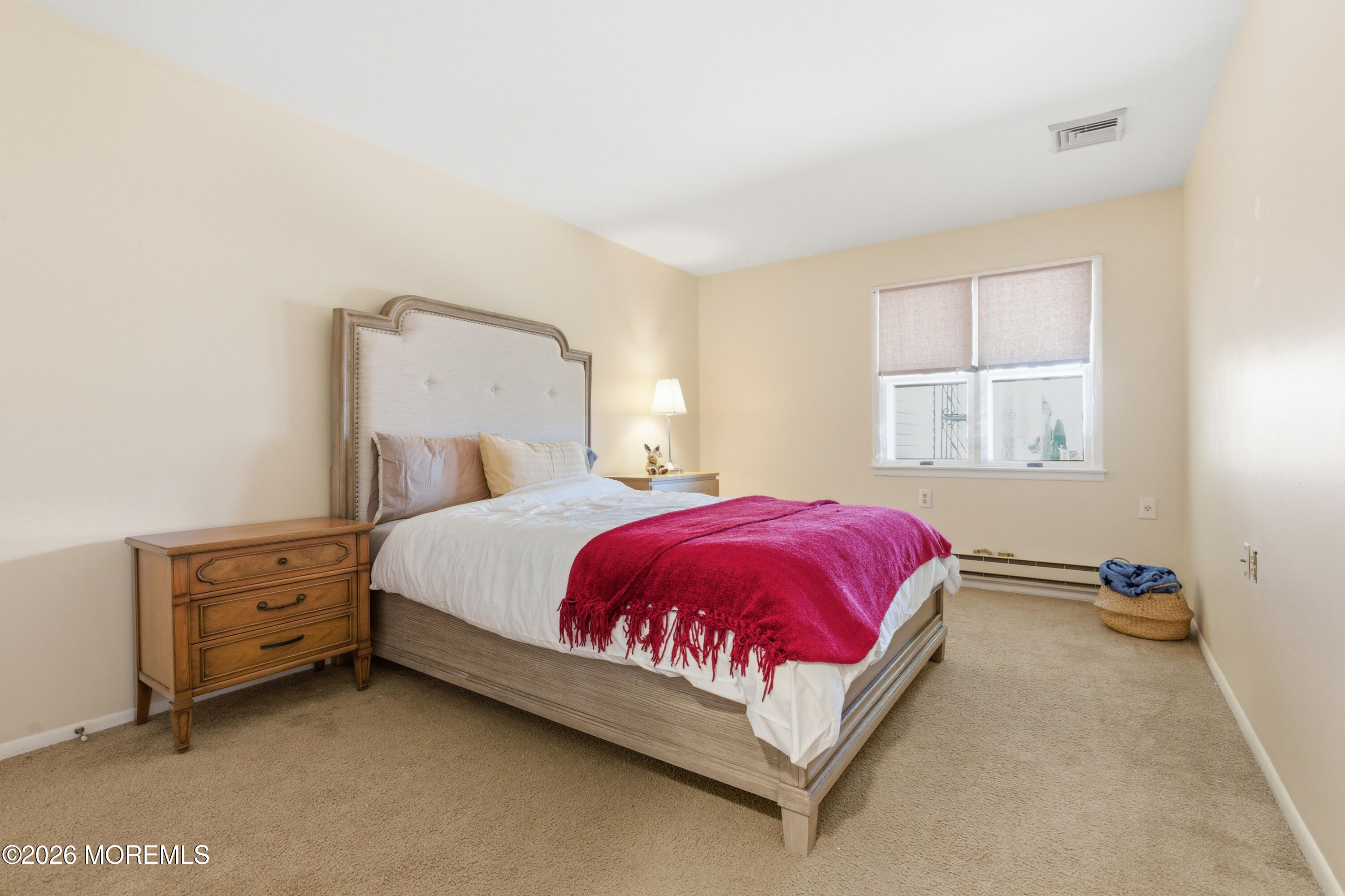 43 A Magnolia Road Manahawkin, NJ 08050 - Photo 14 of 18 a bed sitting in a bedroom next to a window