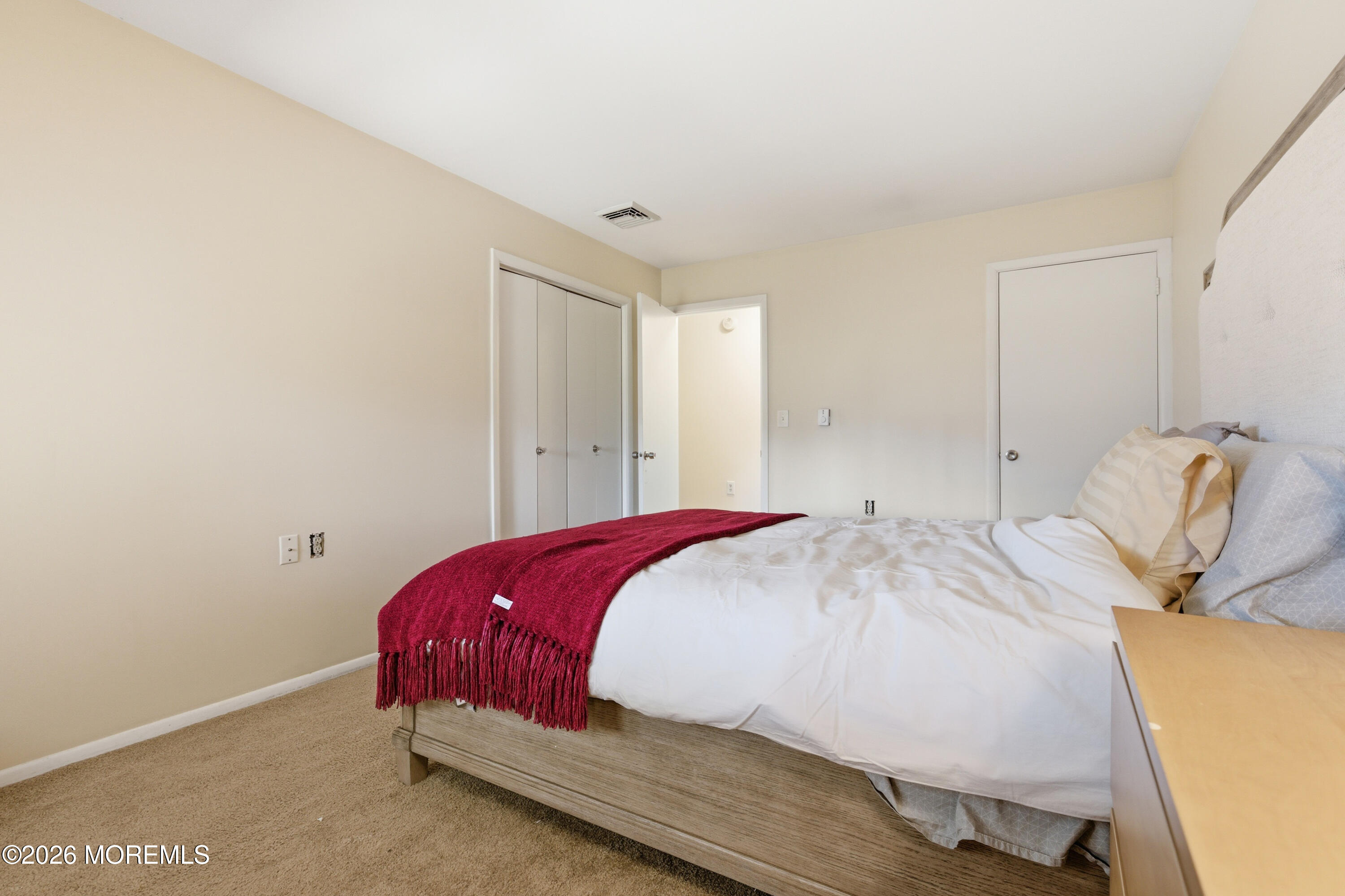 43 A Magnolia Road Manahawkin, NJ 08050 - Photo 15 of 18 a bedroom with a bed and a chair