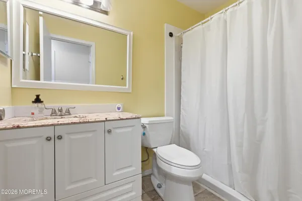 a bathroom with a toilet a sink and a mirror