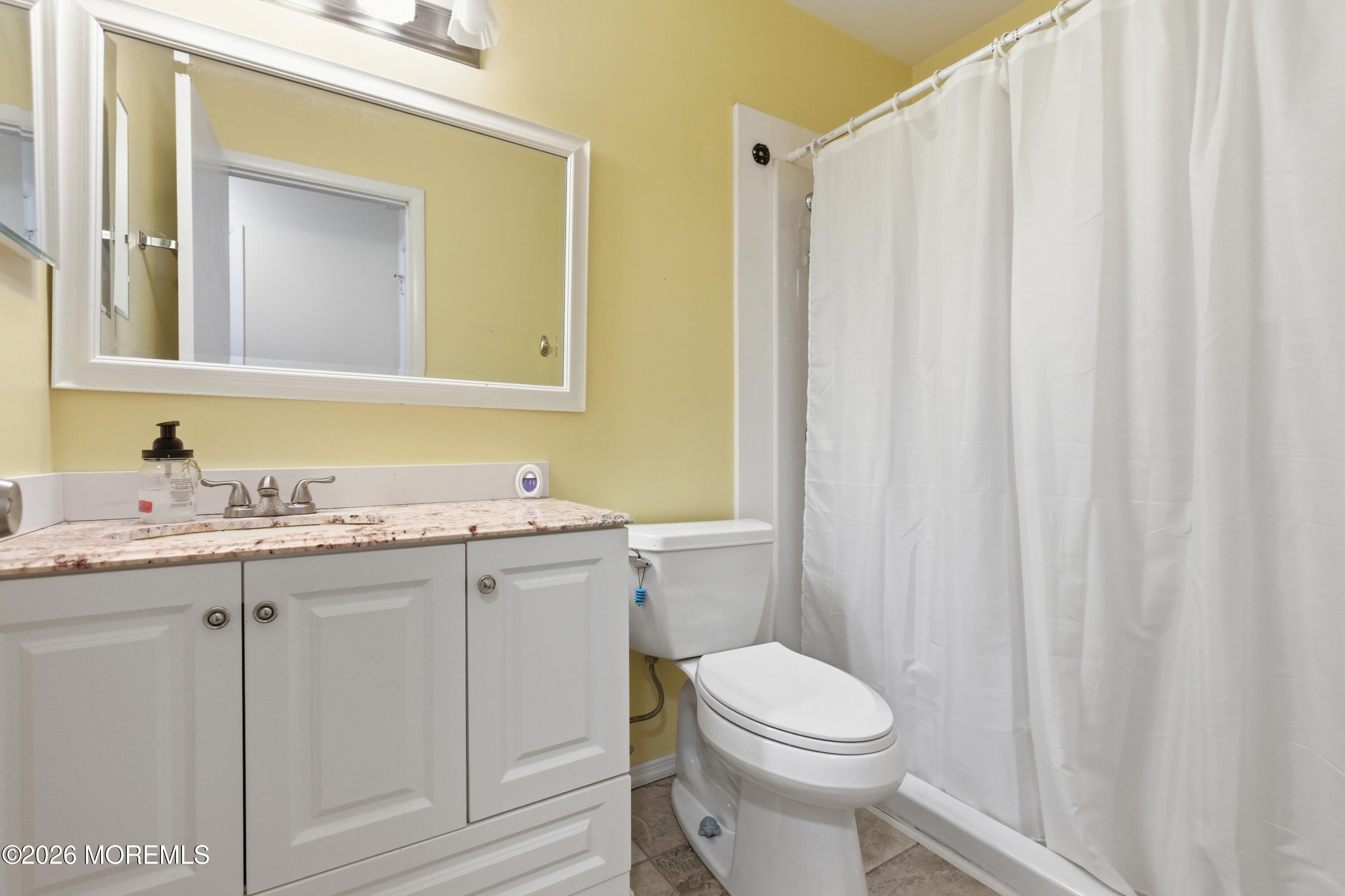 43 A Magnolia Road Manahawkin, NJ 08050 - Photo 17 of 18 a bathroom with a toilet a sink and a mirror