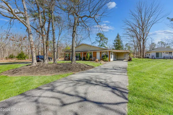 a front view of house with a garden