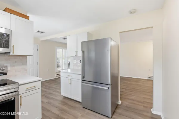 a kitchen with stainless steel appliances a refrigerator and a stove top oven