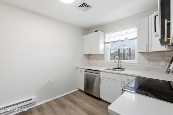 a kitchen with a sink cabinets and a window