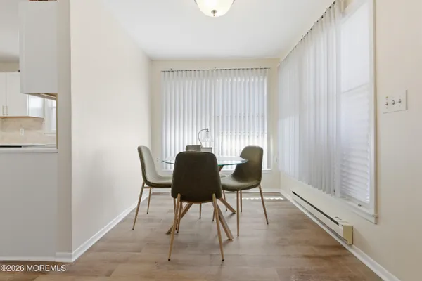 a view of a dining room with furniture and window