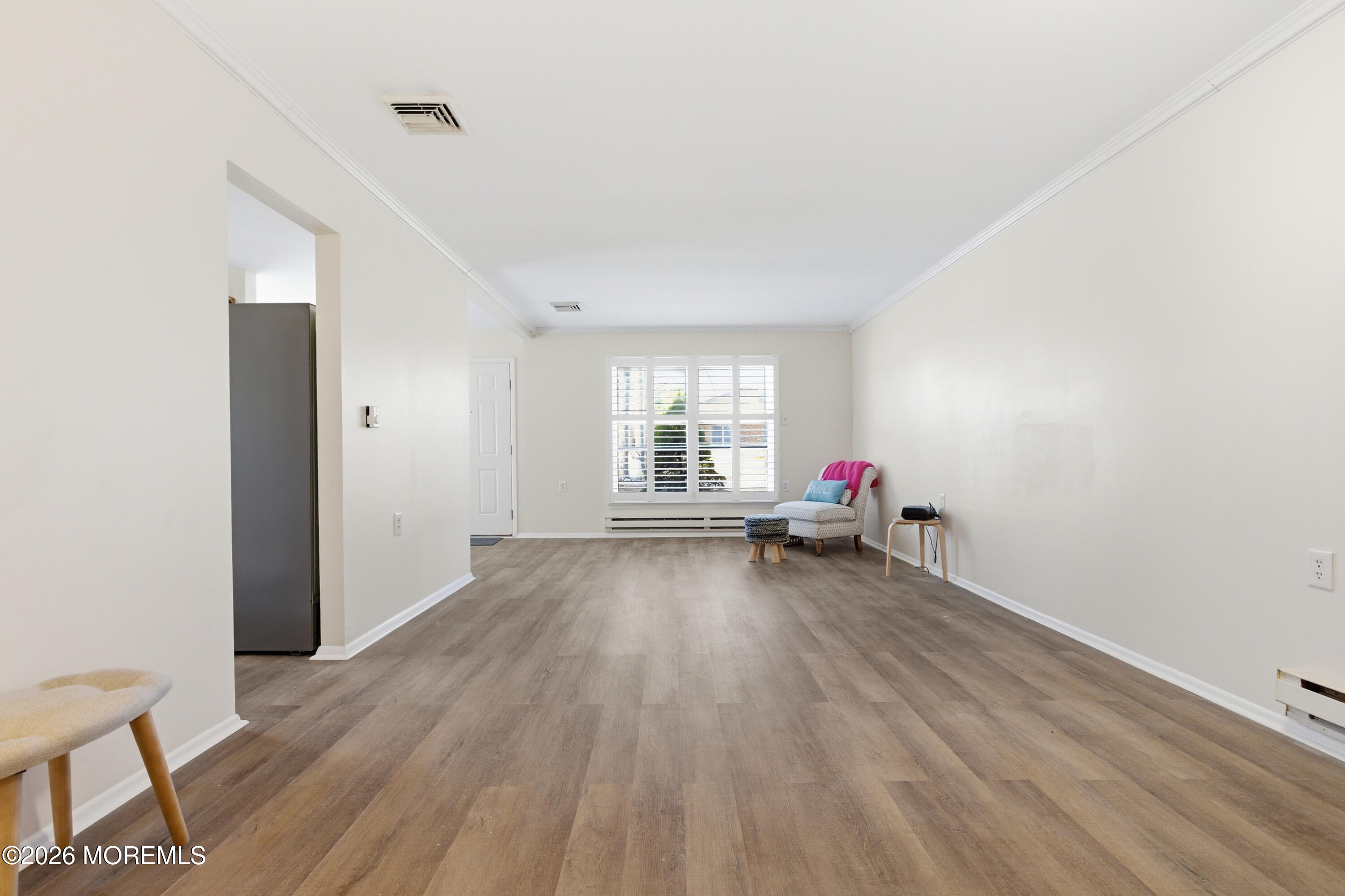 43 A Magnolia Road Manahawkin, NJ 08050 - Photo 10 of 18 a view of a livingroom with wooden floor and white walls