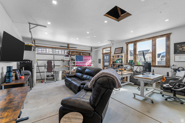 1426 South 1450th Street West Mapleton, UT 84664 - Photo 46 of 50 Spacious room featuring a concrete floor, overhead lighting, and abundant natural light from multiple windows