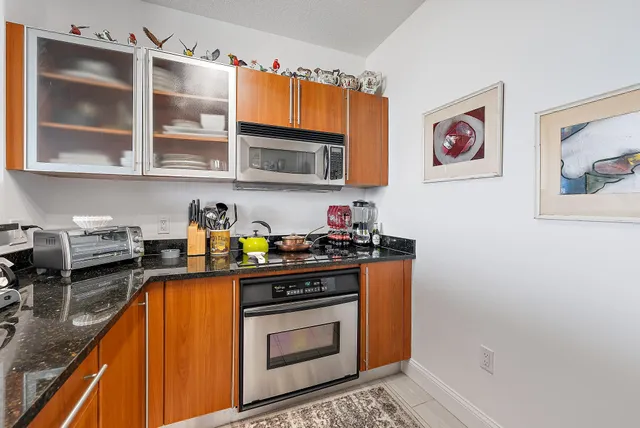 a living room with furniture kitchen view and large windows