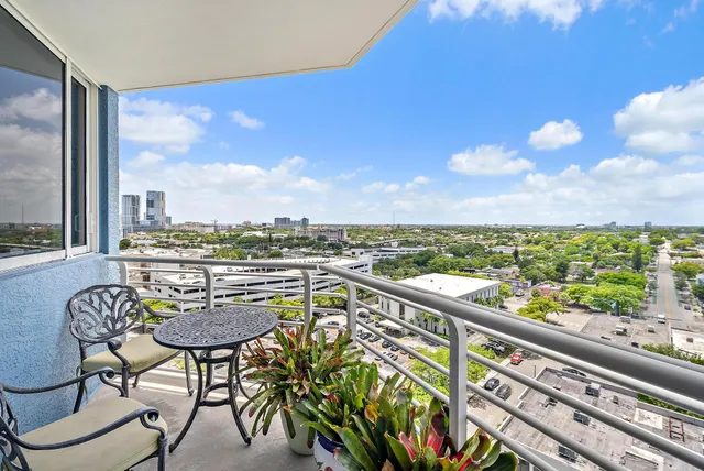 a view of a chairs and table in a balcony