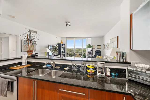a kitchen with stainless steel appliances granite countertop a stove and a sink