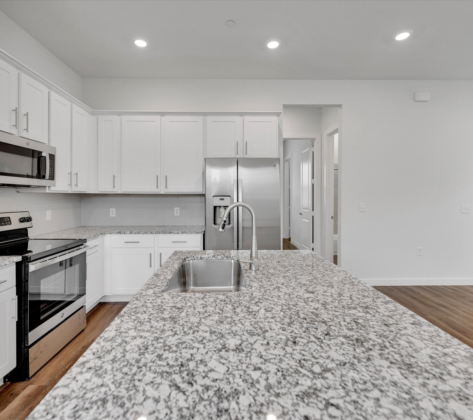 2709-602 Rockhill Road McKinney, TX 75072 - Photo 5 of 19 a kitchen with stainless steel appliances granite countertop a refrigerator sink and cabinets