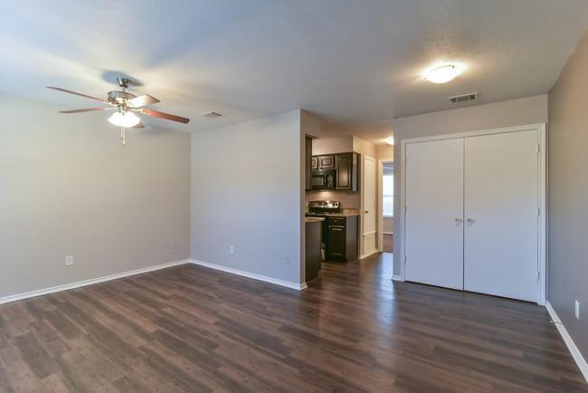 820 Southeast Parkway Azle, TX 76020 - Photo 5 of 9 a view of empty room with wooden floor and ceiling fan