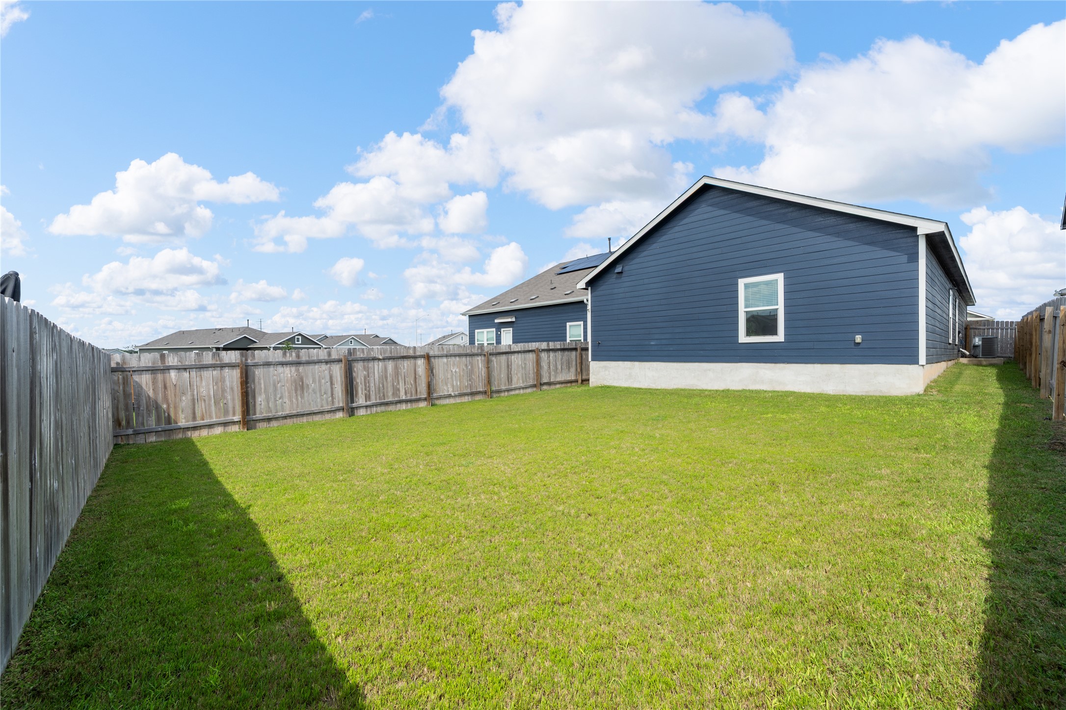 14404 Berning Road Manor, TX 78653 - Photo 36 of 38 A spacious, enclosed green yard offers private outdoor living.