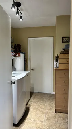 a room with pool table and chairs