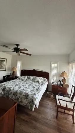 a large bed sitting in a bedroom next to a window