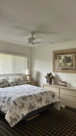 a bedroom with a bed and dresser