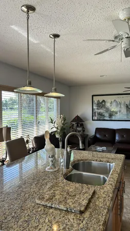 a view of a kitchen with a sink and a large window