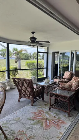 a view of a workspace with furniture and floor to ceiling window
