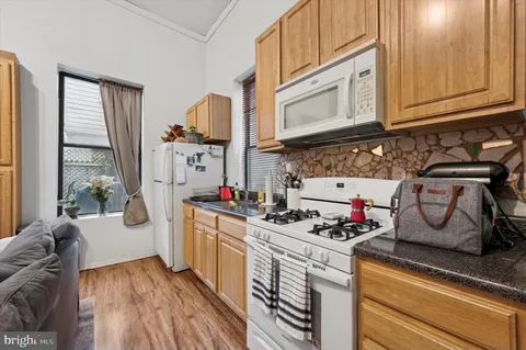 a kitchen with stainless steel appliances granite countertop a stove and cabinets