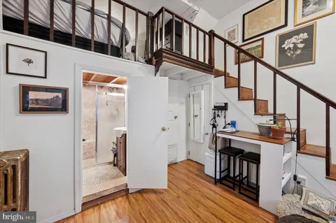 a view of entryway and hall with wooden floor