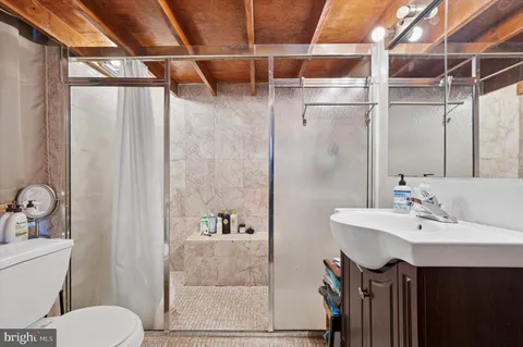 a bathroom with a sink toilet and shower