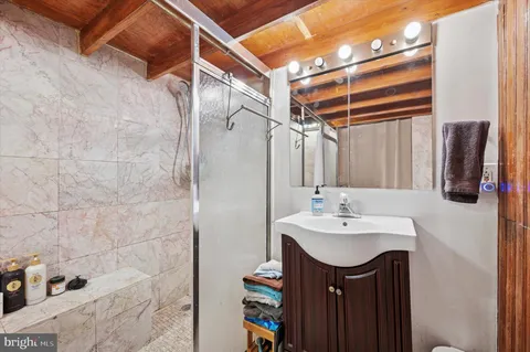 a bathroom with a sink vanity and a mirror
