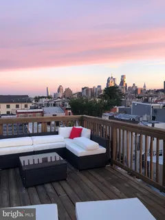 a view of roof deck with a table and chairs