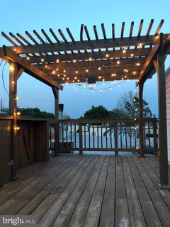 a view of balcony with furniture and wooden floor