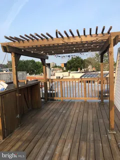 a view of a balcony with wooden floor