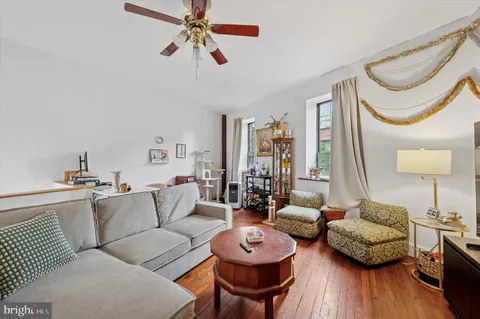 a living room with furniture a rug and a wooden floor