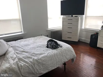 a bedroom with a bed and a dresser