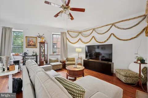 a living room with furniture a fireplace and a chandelier