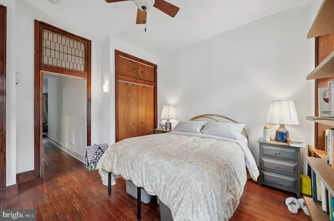 a bedroom with a bed and a flat tv screen on dresser