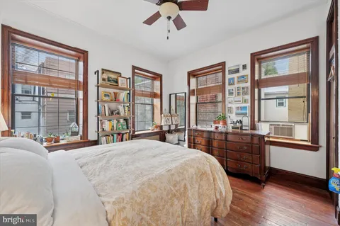 a bedroom with a large bed and a large window