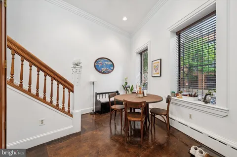 a dining room with furniture and a window