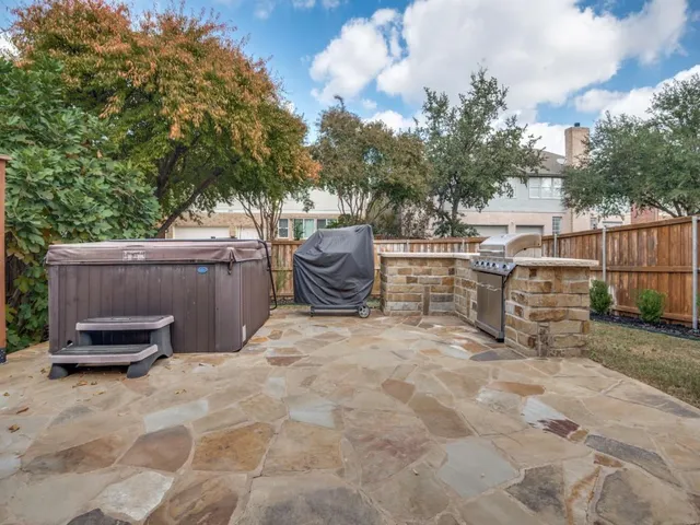 a view of backyard with outdoor seating and trees