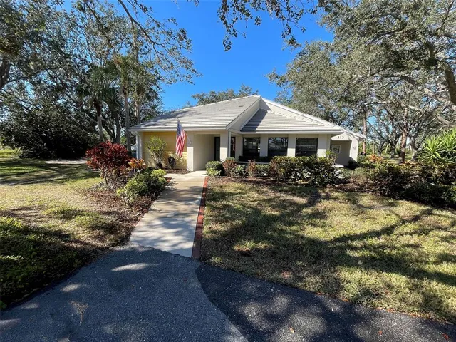 a living room with furniture a piano and a bookshelf