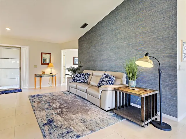 a livingroom with dining area a chandelier a wooden table and chairs