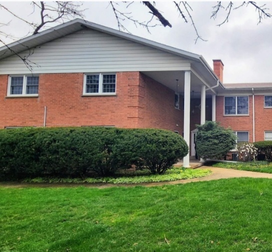 1450 Wing Street, Unit 2B Elgin, IL 60123 - Photo 1 of 17 a front view of a house with a yard