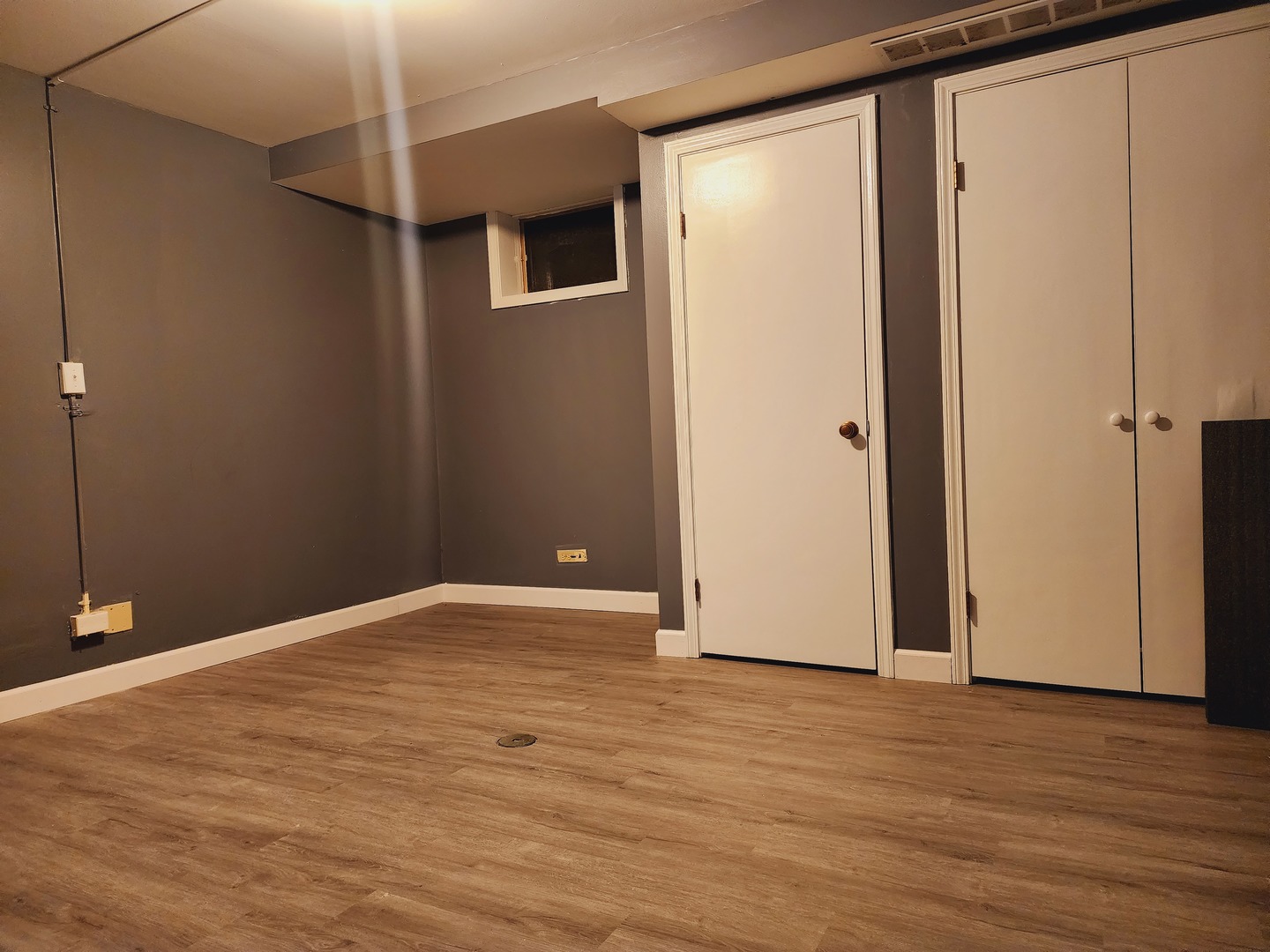 1450 Wing Street, Unit 2B Elgin, IL 60123 - Photo 6 of 17 a view of an empty room with wooden floor and a window