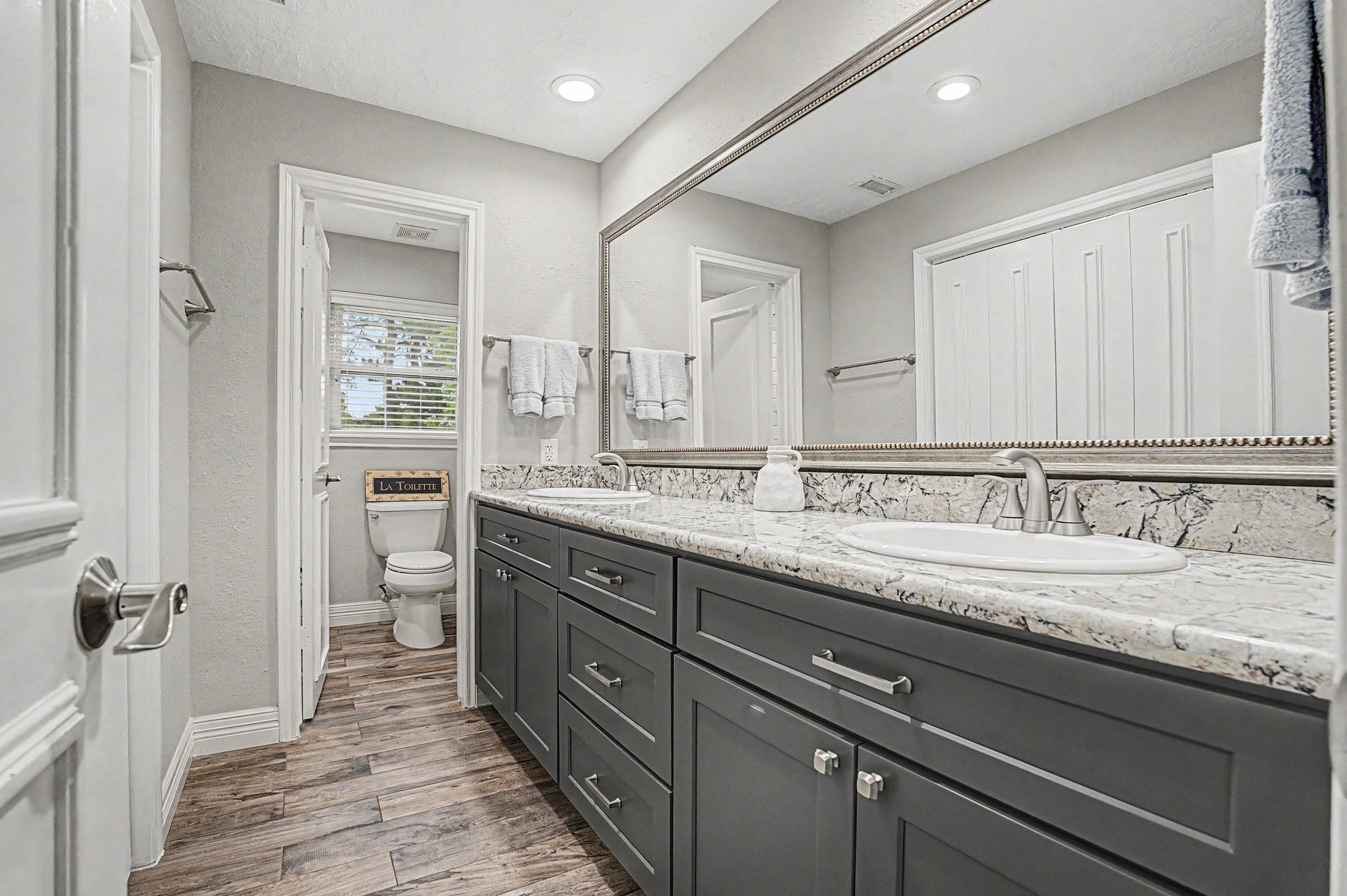 35564 Brumlow Road Hempstead, TX 77445 - Photo 24 of 46 a spacious bathroom with a granite countertop sink a toilet and a mirror