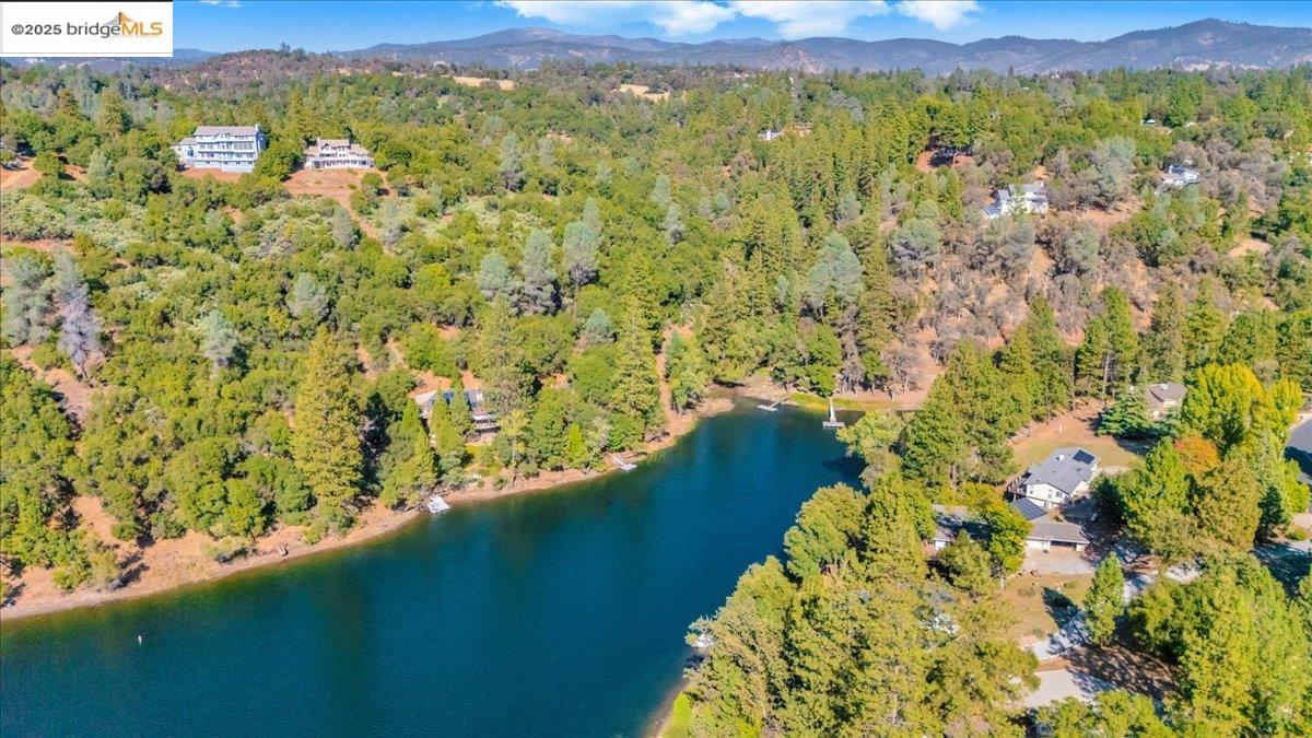 20275 Ferret Court Groveland, CA 95321 - Photo 5 of 9 a view of a lake with a mountain in the background