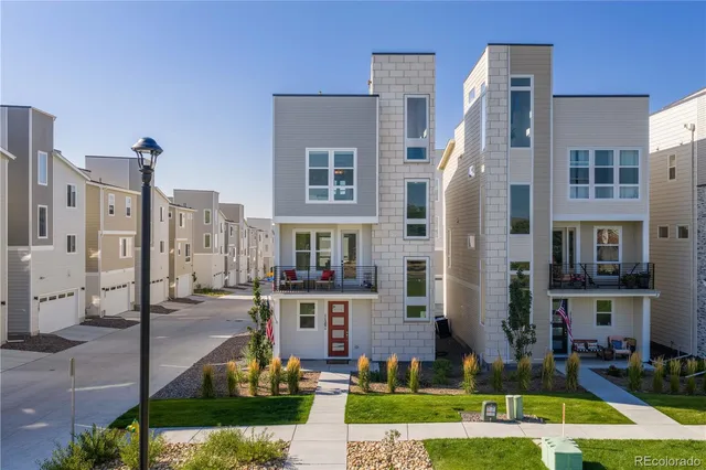 a view of multiple houses with a yard