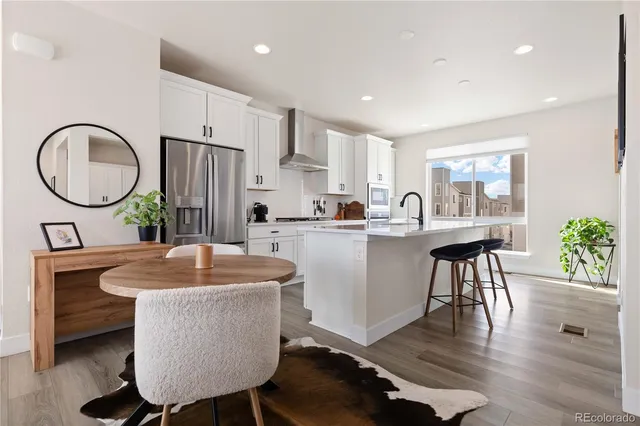 a kitchen with sink a table and chairs