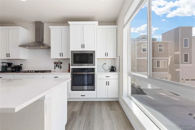 a kitchen with stainless steel appliances a refrigerator and a stove