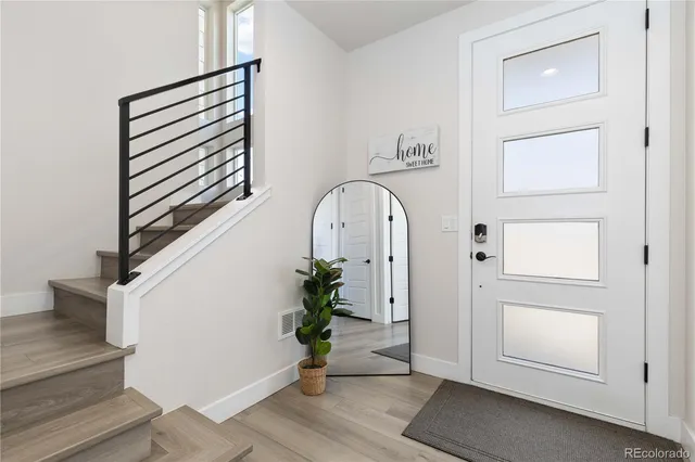 an entryway with wooden floor