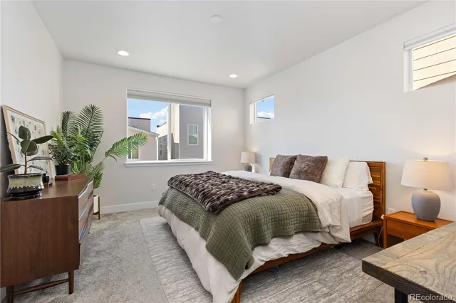a bedroom with a bed and a potted plant