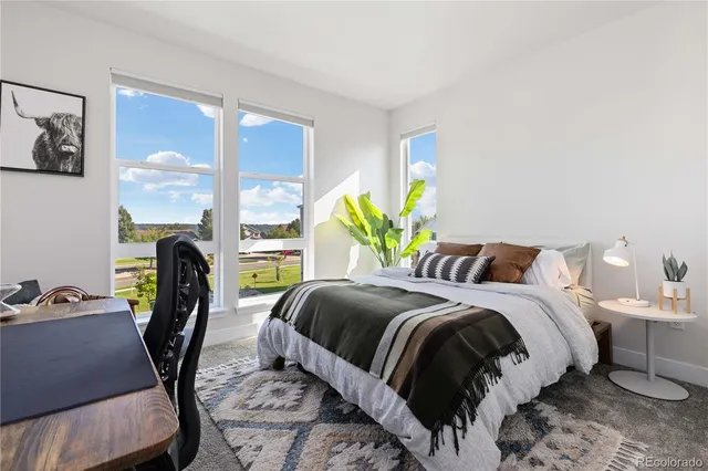 a bed sitting in a bedroom next to a window