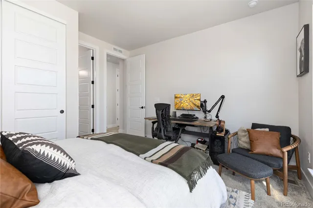 a bedroom with a bed and a lounge chair